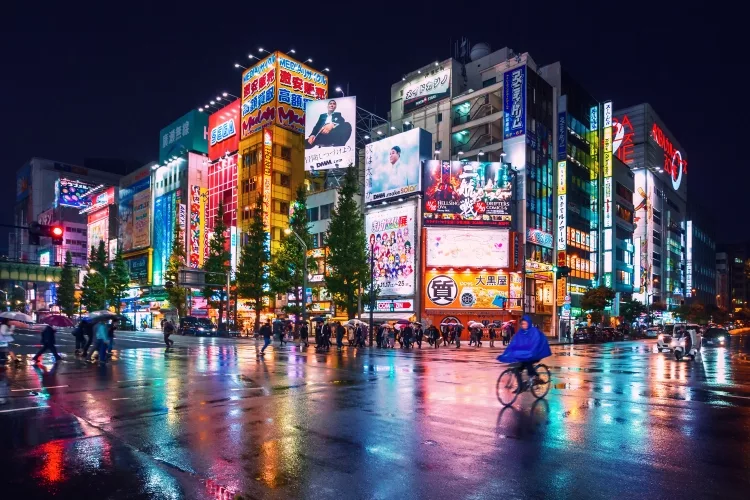 Neon lights and billboard advertisements on buildings at Akihabara at rainy night, Tokyo, Japan